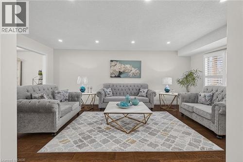 Spacious interior featuring wood-finish flooring, recessed lighting, and white walls - 79 Holbrook Crescent, Cambridge, ON - Indoor Photo Showing Living Room
