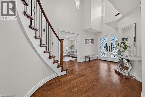 Grand entryway featuring a curved staircase with dark wood treads and wrought iron balusters - 79 Holbrook Crescent, Cambridge, ON - Indoor Photo Showing Other Room