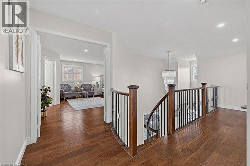 Curved staircase with wood-finish handrails and black metal balusters - 79 Holbrook Crescent, Cambridge, ON - Indoor Photo Showing Other Room
