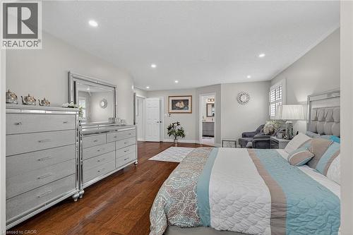 Hardwood flooring complements light gray walls throughout this spacious bedroom - 79 Holbrook Crescent, Cambridge, ON - Indoor Photo Showing Bedroom