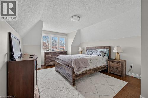 Hardwood flooring and light wall colors enhance this bedroom with sloped ceilings - 79 Holbrook Crescent, Cambridge, ON - Indoor Photo Showing Bedroom
