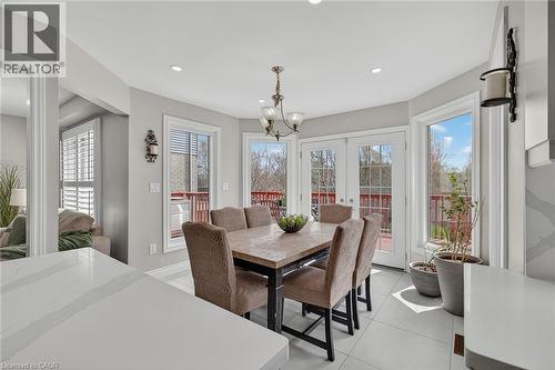 Dining area with double glass panel doors opening to an exterior deck - 79 Holbrook Crescent, Cambridge, ON - Indoor Photo Showing Dining Room