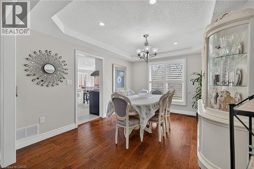 Dining area featuring rich wood-finish flooring, a tray ceiling, and recessed lighting - 79 Holbrook Crescent, Cambridge, ON - Indoor Photo Showing Dining Room