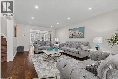 Recessed lighting illuminates the living area featuring wood-finish flooring and light-toned walls - 79 Holbrook Crescent, Cambridge, ON - Indoor Photo Showing Living Room