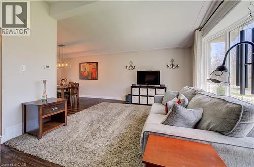 Living space featuring wood-finish flooring, a plush area rug, and a large bay window - 172 Rennie Drive, Kitchener, ON - Indoor