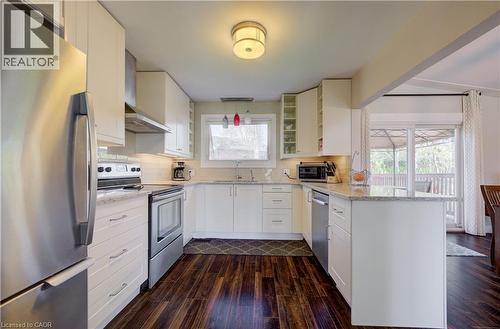 Kitchen featuring wood-finish flooring, white cabinetry, stainless steel appliances, and light-colored countertops - 172 Rennie Drive, Kitchener, ON - Indoor Photo Showing Kitchen