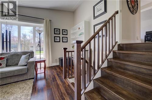 Rich wood-finish staircase with matching banister and balusters - 172 Rennie Drive, Kitchener, ON - Indoor Photo Showing Other Room