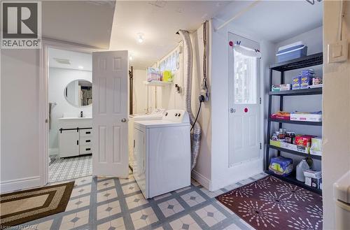 Laundry area featuring patterned tile flooring, a washer, and a storage rack - 172 Rennie Drive, Kitchener, ON - Indoor Photo Showing Laundry Room