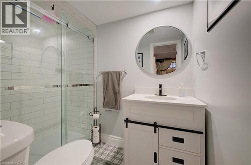 Glass-enclosed shower with subway tile surround and a circular accent detail - 172 Rennie Drive, Kitchener, ON - Indoor Photo Showing Bathroom