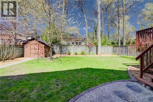 Expansive green lawn surrounded by mature trees and privacy fencing - 172 Rennie Drive, Kitchener, ON - Outdoor
