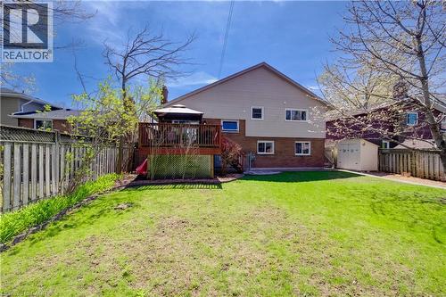 Expansive backyard featuring a manicured lawn, a two-story deck with a gazebo, and a storage shed - 172 Rennie Drive, Kitchener, ON - Outdoor