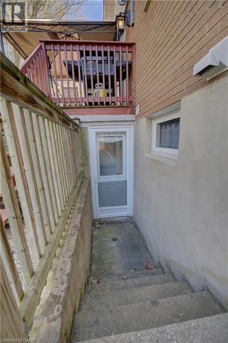 Concrete exterior stairway leading to a white entry door with a screen door - 172 Rennie Drive, Kitchener, ON - Outdoor