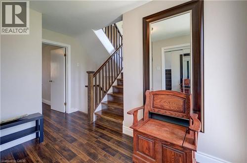 Entryway featuring wood-finish flooring, a wood staircase with balusters, and a full-length mirror - 172 Rennie Drive, Kitchener, ON - Indoor Photo Showing Other Room