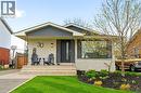 Modern bungalow facade featuring light brick and dark siding - 30 Darlington Drive, Hamilton, ON  - Outdoor With Deck Patio Veranda 
