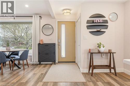 Entryway featuring wood-finish flooring and a contemporary front door with a frosted glass panel - 30 Darlington Drive, Hamilton, ON - Indoor Photo Showing Other Room