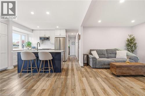 Open-concept living area featuring wood-finish flooring throughout - 30 Darlington Drive, Hamilton, ON - Indoor