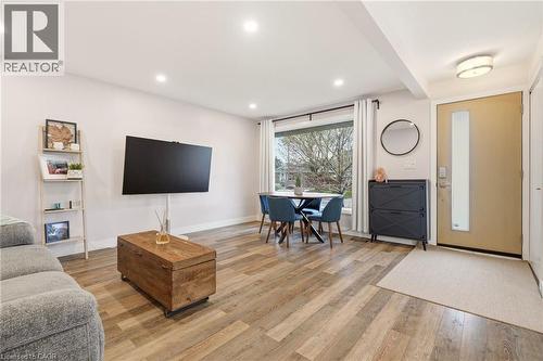 Open-concept living space featuring wood-finish flooring, recessed lighting, and a large front window - 30 Darlington Drive, Hamilton, ON - Indoor Photo Showing Living Room