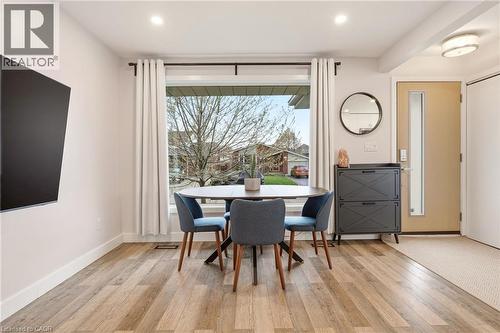 Entryway featuring a solid door with a vertical glass insert, wood-finish flooring, and recessed lighting - 30 Darlington Drive, Hamilton, ON - Indoor Photo Showing Dining Room