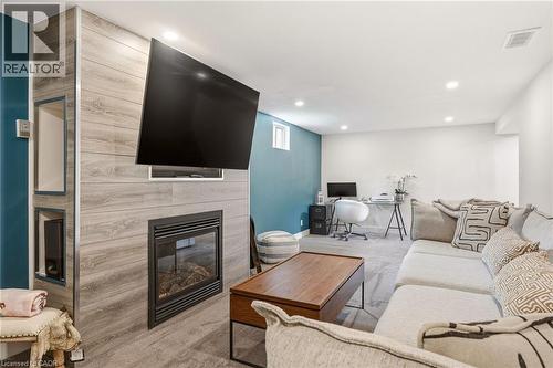 Entertainment space featuring a linear fireplace with a mounted television above - 30 Darlington Drive, Hamilton, ON - Indoor Photo Showing Living Room With Fireplace