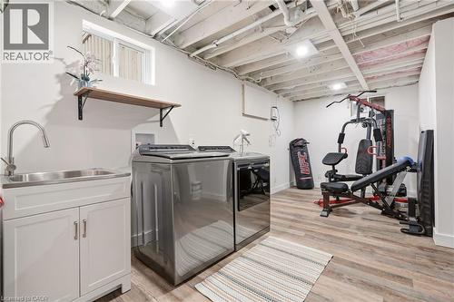 Lower-level utility area featuring wood-finish flooring and recessed lighting - 30 Darlington Drive, Hamilton, ON - Indoor Photo Showing Gym Room