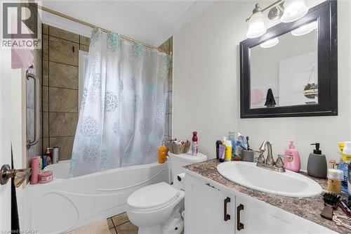 Bathroom featuring a single vanity with an oval sink, a framed mirror, and a three-light fixture - 406 East 43Rd Street, Hamilton, ON - Indoor Photo Showing Bathroom