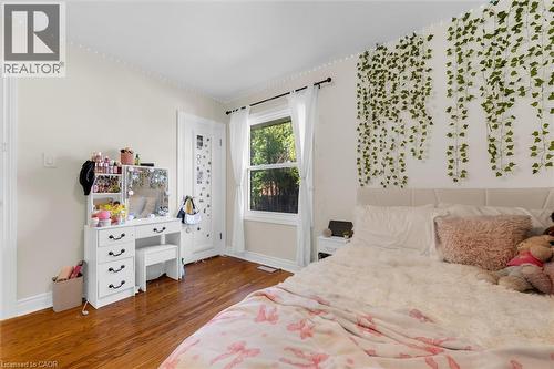 Hardwood flooring throughout featuring white trim and baseboards - 406 East 43Rd Street, Hamilton, ON - Indoor Photo Showing Bedroom