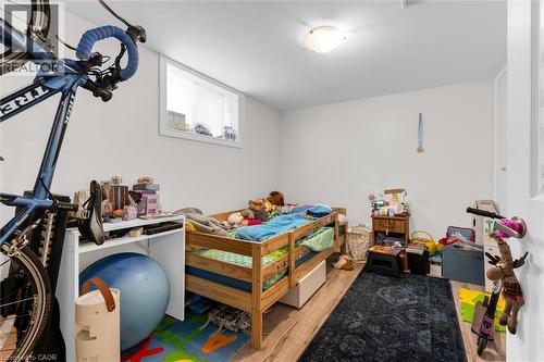 Room featuring wood-finish flooring, a single window, and a flush-mount ceiling light fixture - 406 East 43Rd Street, Hamilton, ON - Indoor