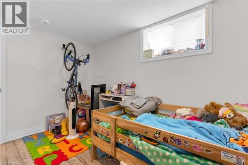 Bright interior space featuring a window with white trim, light-colored walls, and wood-finish flooring - 406 East 43Rd Street, Hamilton, ON - Indoor