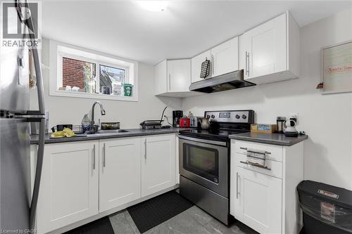Kitchen featuring white cabinetry, stainless steel appliances, a window above the sink, and grey countertops - 406 East 43Rd Street, Hamilton, ON - Indoor Photo Showing Kitchen