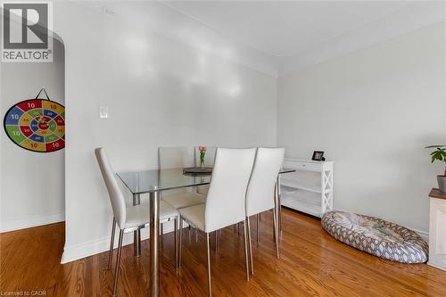 Dining area featuring wood-finish flooring, white baseboards, and light-toned walls - 406 East 43Rd Street, Hamilton, ON - Indoor Photo Showing Dining Room