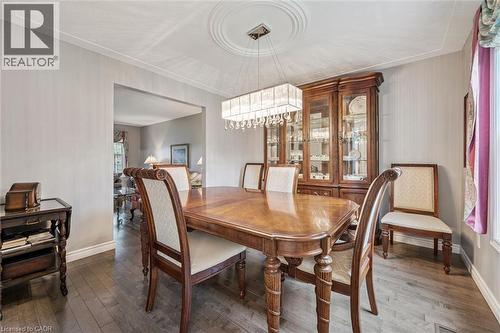 Dining area featuring wood-finish flooring, a decorative ceiling medallion, and crown molding - 42 Trailview Drive, Kitchener, ON - Indoor Photo Showing Dining Room