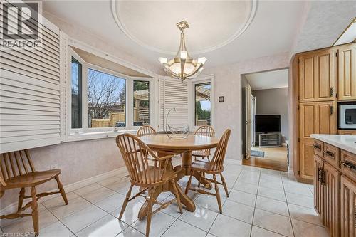 Dining area featuring a bay window with plantation shutters, a decorative ceiling medallion, and a chandelier - 42 Trailview Drive, Kitchener, ON - Indoor Photo Showing Dining Room