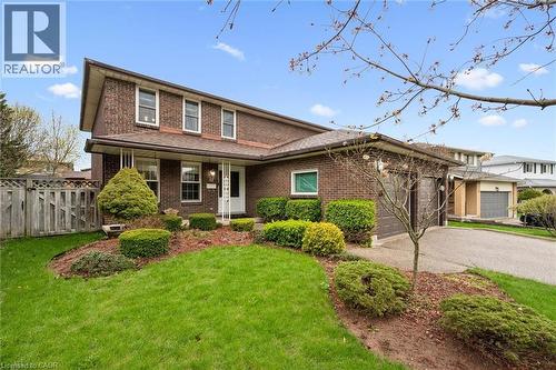 Brick exterior featuring a covered entry porch, integrated garage, and a sloped roofline - 42 Trailview Drive, Kitchener, ON - Outdoor