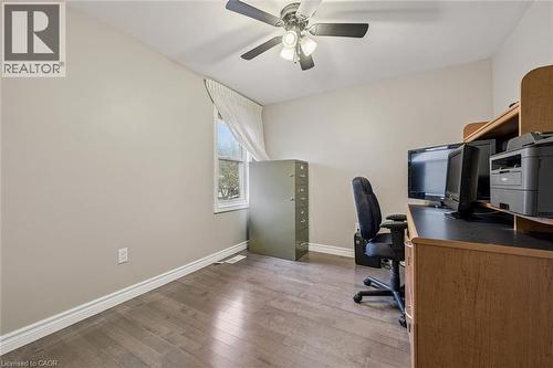 Room featuring wood-finish flooring, a ceiling fan with integrated lighting, and a single window with white trim - 42 Trailview Drive, Kitchener, ON - Indoor Photo Showing Office