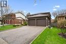 Brick exterior residence featuring a two-car garage with panel doors, a concrete driveway, and a shingled roof - 42 Trailview Drive, Kitchener, ON  - Outdoor 