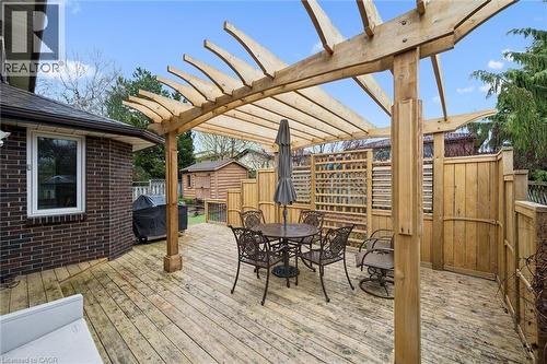 Spacious wood-finish deck featuring a substantial pergola, privacy lattice, solid wood fencing, and a brick exterior - 42 Trailview Drive, Kitchener, ON - Outdoor With Deck Patio Veranda