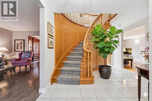 Grand foyer featuring a curved staircase with wood banister and carpeted steps - 42 Trailview Drive, Kitchener, ON - Indoor Photo Showing Other Room