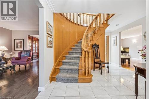 Grand curved staircase featuring wood banisters and a carpet runner - 42 Trailview Drive, Kitchener, ON - Indoor Photo Showing Other Room