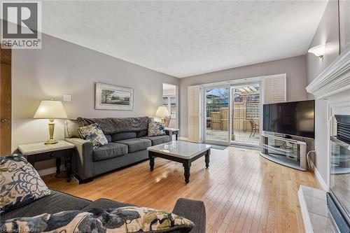 Living area featuring wood-finish flooring, light gray wall paint, and a textured ceiling - 42 Trailview Drive, Kitchener, ON - Indoor Photo Showing Living Room