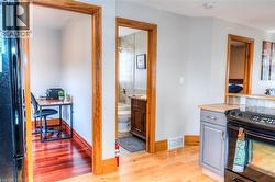Light wood-finish flooring extending into a dedicated nook featuring a rich wood-finish floor - 