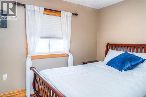 Window with wood trim, cellular blinds, and decorative curtain rod - 46 2 Avenue, Kitchener, ON - Indoor Photo Showing Bedroom
