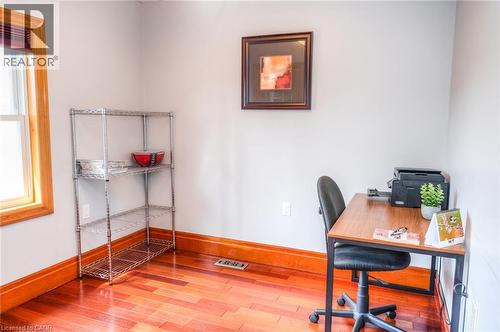 Room featuring wood-finish flooring, light grey walls, and natural wood trim around the window and baseboards - 46 2 Avenue, Kitchener, ON - Indoor Photo Showing Office