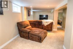 Carpeted recreation area with recessed lighting, painted walls, and white baseboards - 
