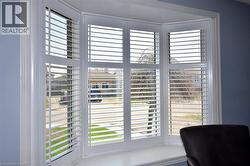 Bay window featuring white plantation shutters and a deep window sill - 