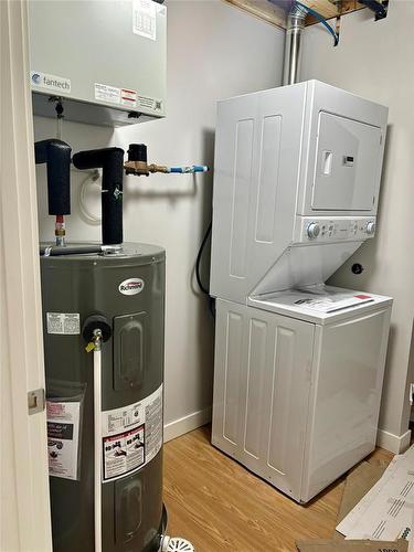 Laundry room with extra storage space in each suite - 1536 9Th Street, Brandon, MB - Indoor Photo Showing Laundry Room