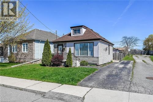Front exterior featuring horizontal siding, a dormer window, and a shingled roof - 192 Ivon Avenue, Hamilton, ON - Outdoor