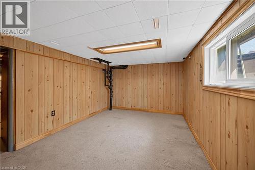 Finished room with wood paneling, drop ceiling, carpet flooring, and a window - 192 Ivon Avenue, Hamilton, ON - Indoor