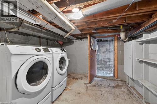 Basement area featuring a concrete floor, exposed joists, and block walls - 192 Ivon Avenue, Hamilton, ON - Indoor Photo Showing Laundry Room