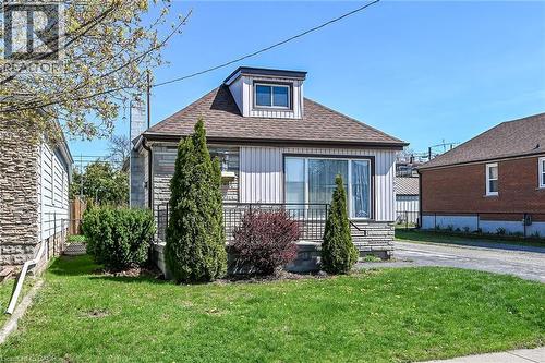 Front elevation featuring vertical siding and stone veneer accents - 192 Ivon Avenue, Hamilton, ON - Outdoor