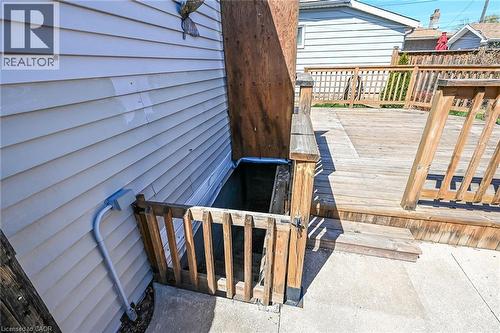 Exterior wood deck with a built-in gate and steps, alongside a white siding wall - 192 Ivon Avenue, Hamilton, ON - Outdoor With Deck Patio Veranda With Exterior